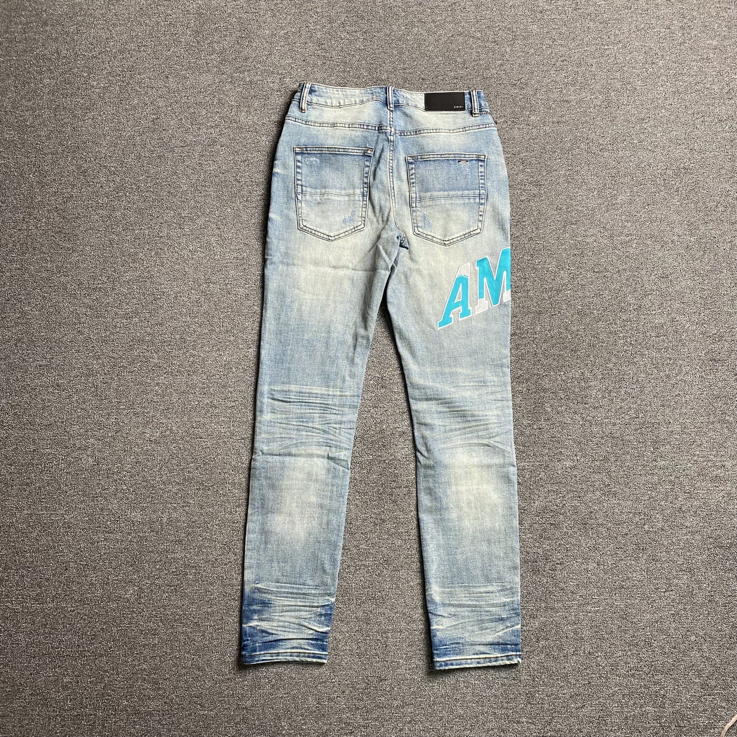 AMIRI VARSITY LOGO JEANS - Prime Reps