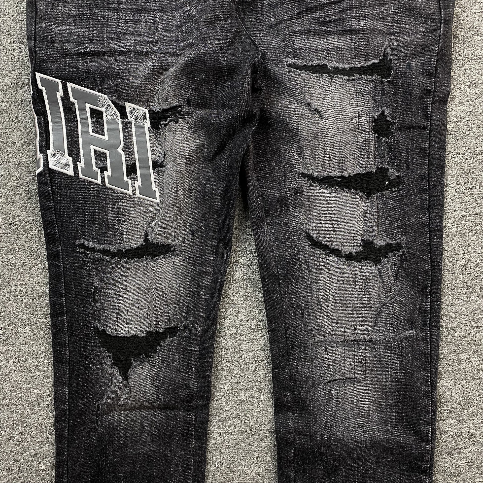 AMIRI VARSITY LOGO REPAIR JEANS - Prime Reps